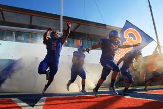 The Bishop Gorman footabll team takes to the field for their season opener against Our Lady of Good Counsel Friday, August 24, 2012.